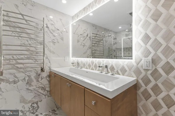 a bathroom with a sink shower vanity and a mirror