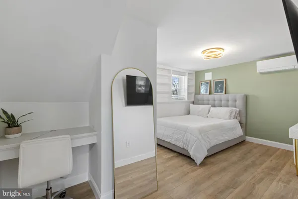 a bedroom with a bed and a potted plant