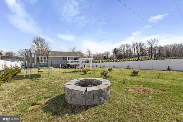 a view of a house with a big yard and large tree