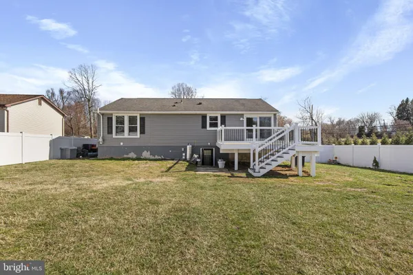 a view of a house with a yard and sitting area
