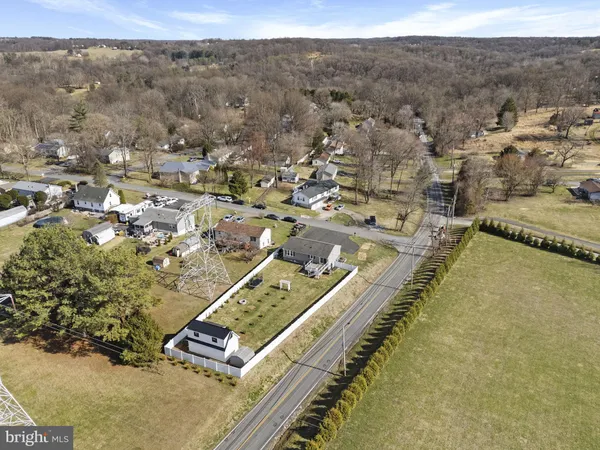 a front view of a house with swimming pool and trees