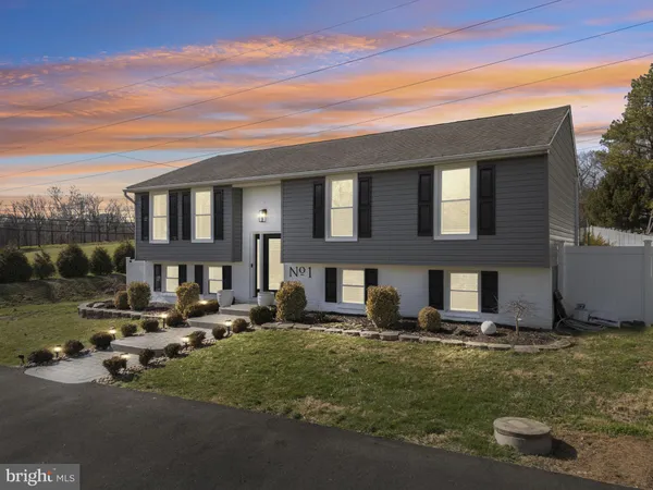 a front view of a building with a yard