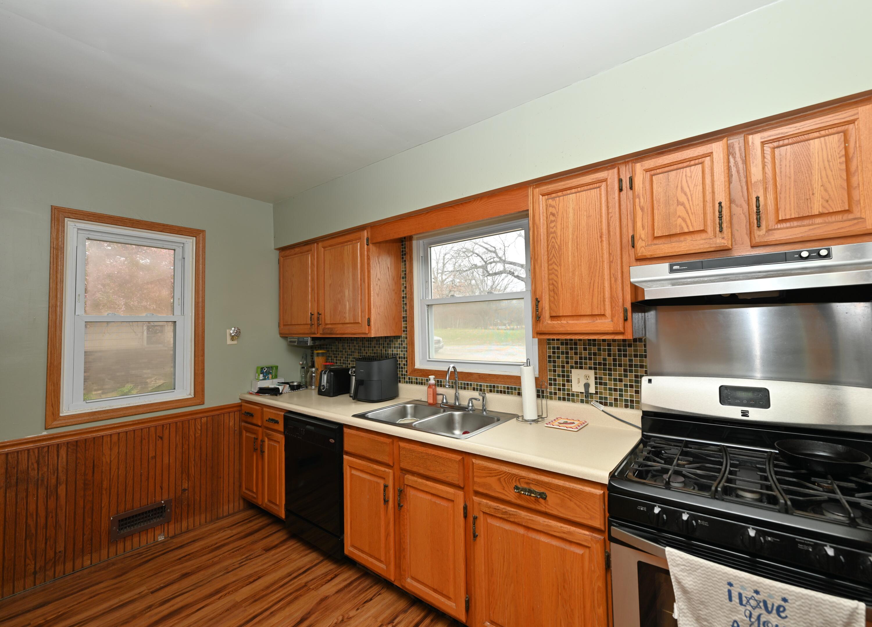 5110 West 400 North Winamac, IN 46996 - Photo 20 of 35 a kitchen with stainless steel appliances granite countertop a sink stove and cabinets