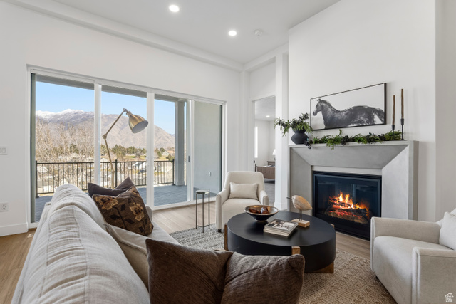 624 North Legend Circle, Unit 480 Mapleton, UT 84664 - Photo 21 of 34 Living area featuring a mountain view, recessed lighting, a glass covered fireplace, and wood finished floors