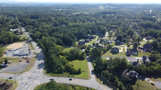 an aerial view of a residential houses with swimming pool