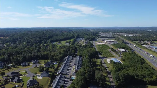 an aerial view of a residential houses with yard