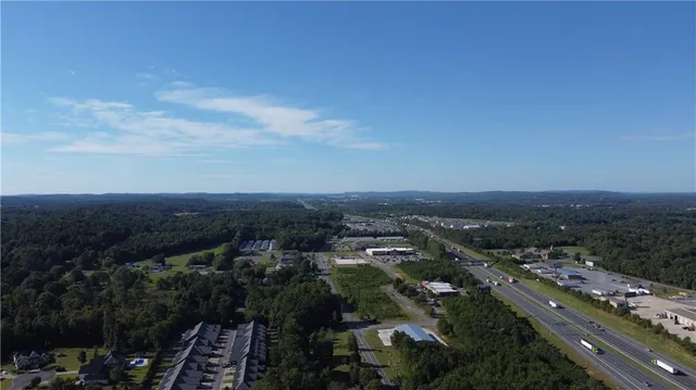 a view of a house with a yard and chairs