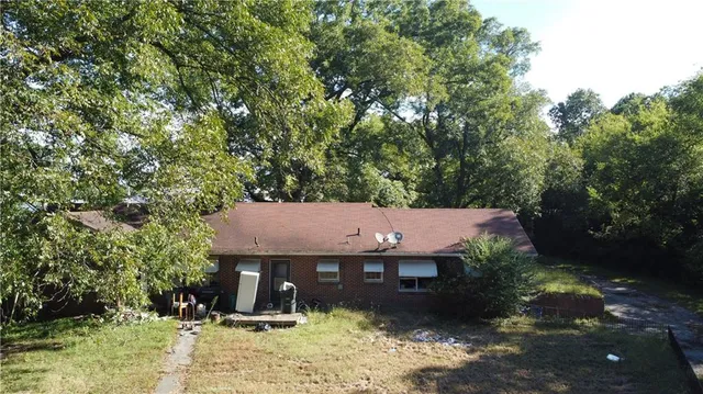 a backyard of a house with yard and outdoor seating