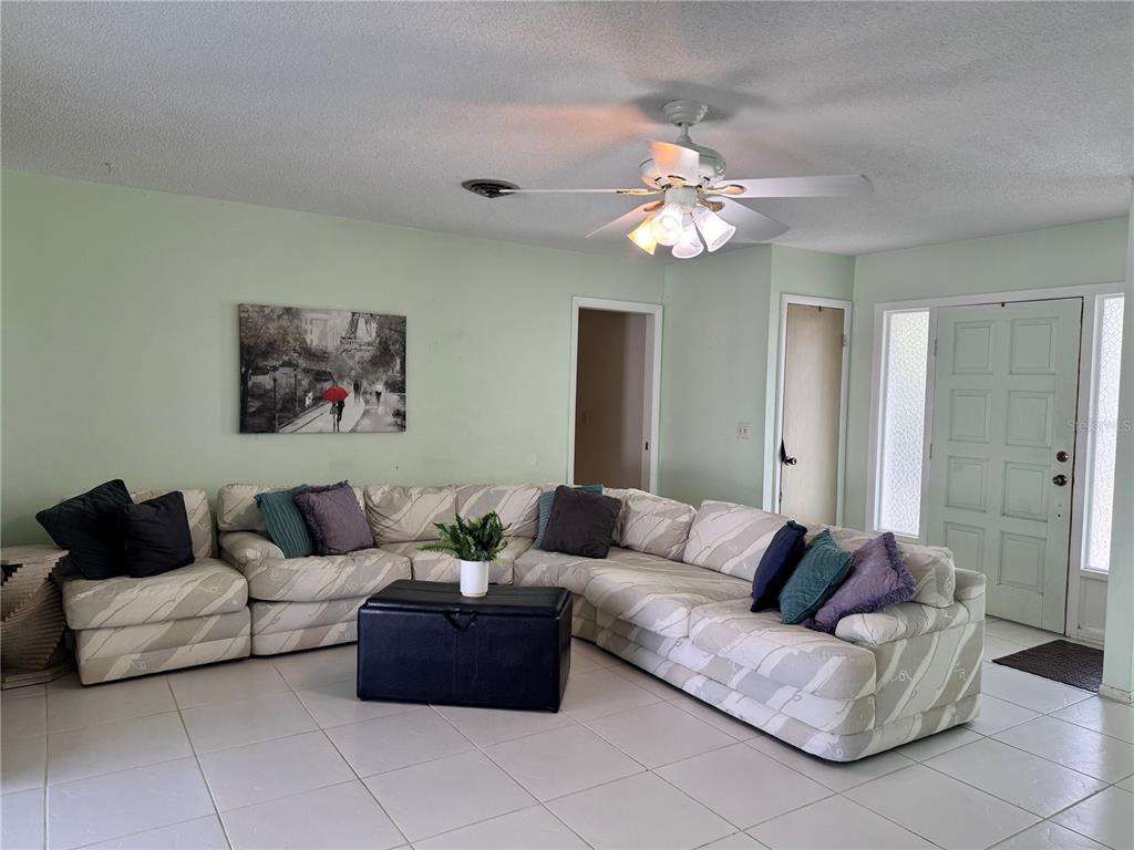 1048 Porpoise Road Venice, FL 34293 - Photo 10 of 26 a living room with furniture and a glass door