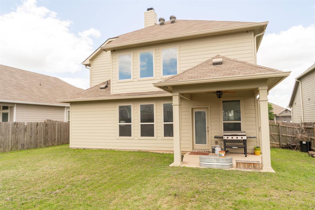 2716 Beutel Road Lorena, TX 76655 - Photo 35 of 39 a view of a house with a patio and a yard