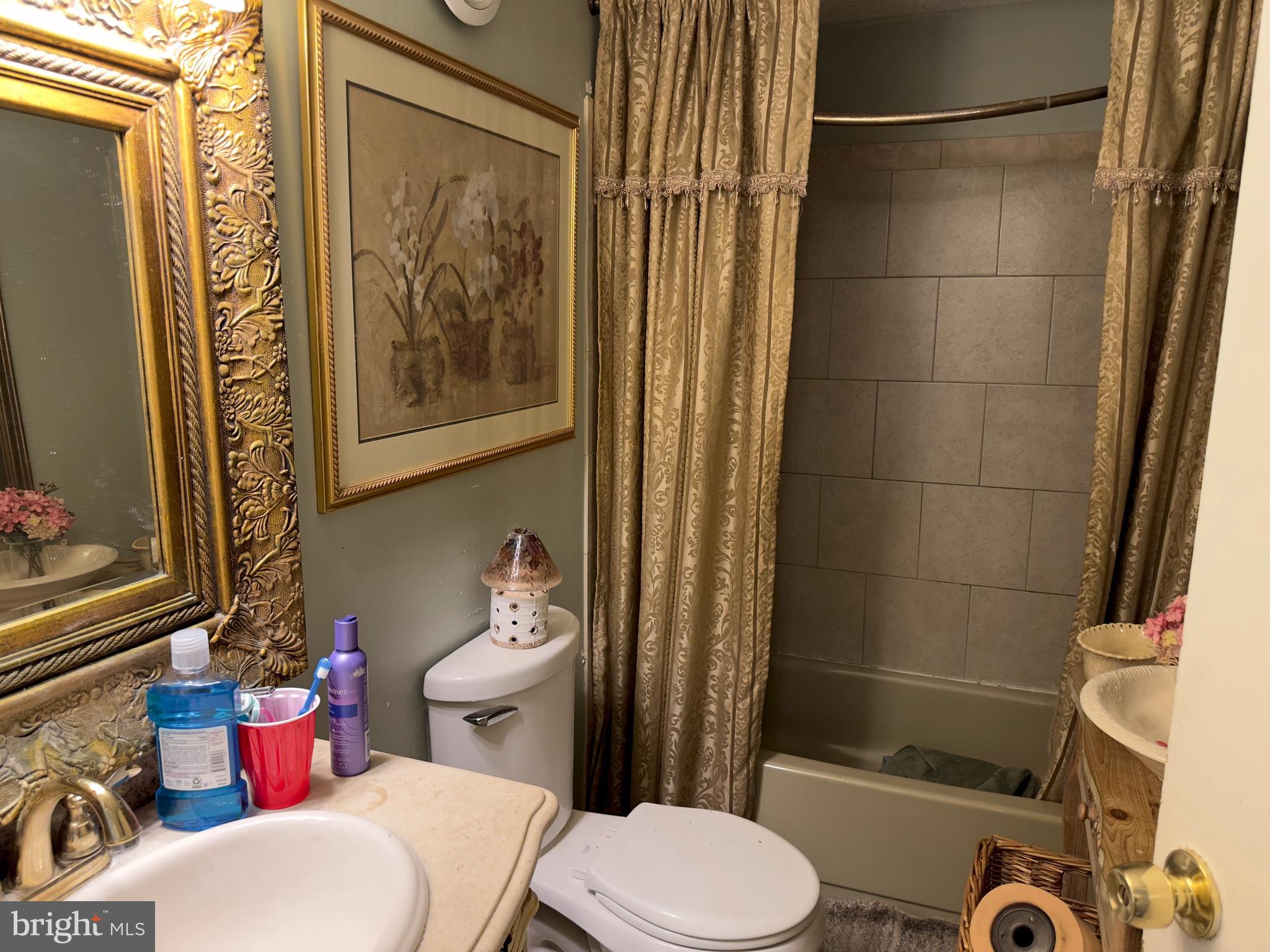 2512 Ridgely Street Baltimore, MD 21230 - Photo 8 of 16 a white toilet sitting next to a bathroom sink and tub