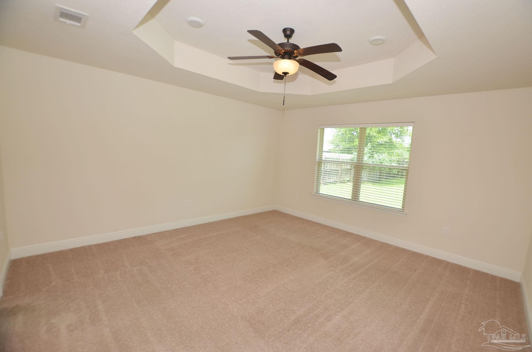5709 Mill Stream Way Pace, FL 32571 - Photo 22 of 48 an empty room with a window and a fan