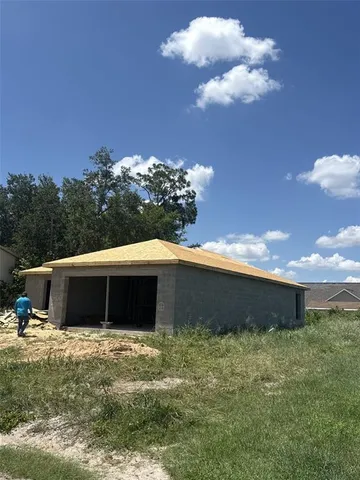a front view of a house with a yard and a garage