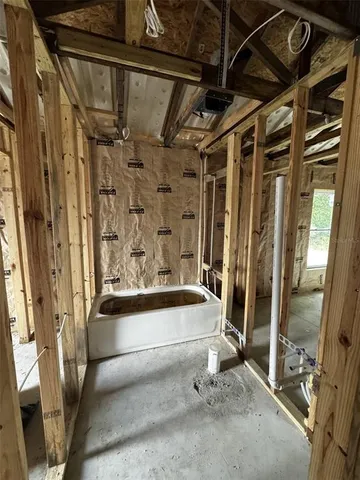 a bathroom with a tub and shower