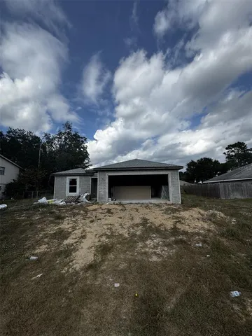 a backyard of a house with table and chairs