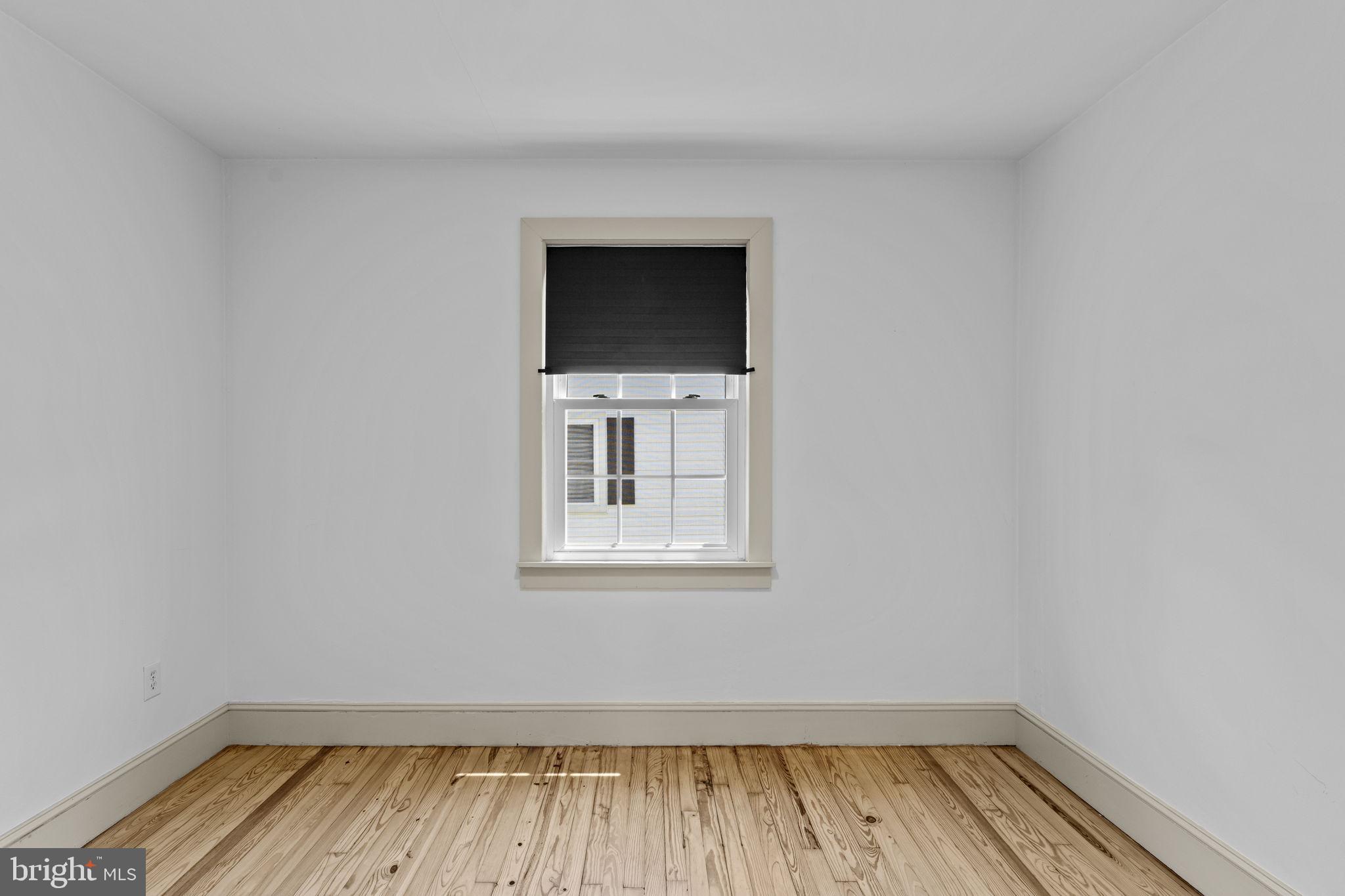 216 Walnut Street Berryville, VA 22611 - Photo 18 of 36 a view of a room with wooden floor and white walls