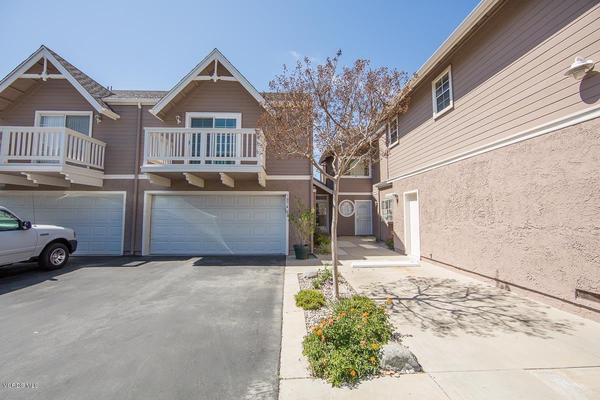 1854 Rory Lane, Unit 3 Simi Valley, CA 93063 - Photo 1 of 29 a view of a house with a yard and garage