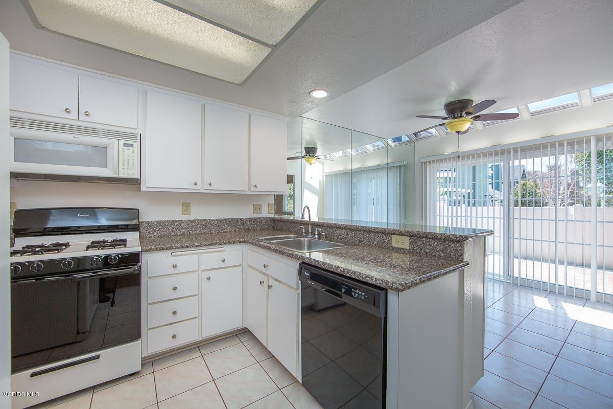 1854 Rory Lane, Unit 3 Simi Valley, CA 93063 - Photo 11 of 29 a kitchen with granite countertop a stove sink and cabinets