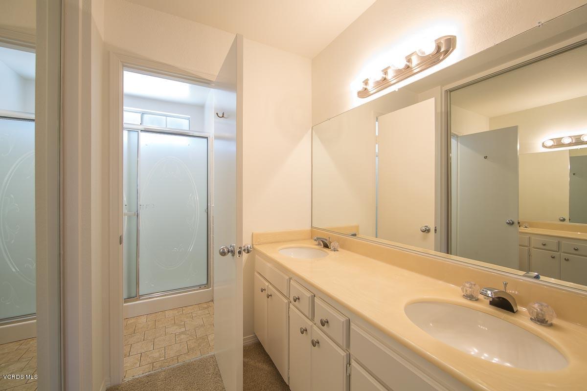 1854 Rory Lane, Unit 3 Simi Valley, CA 93063 - Photo 18 of 29 a bathroom with a double vanity sink and a mirror