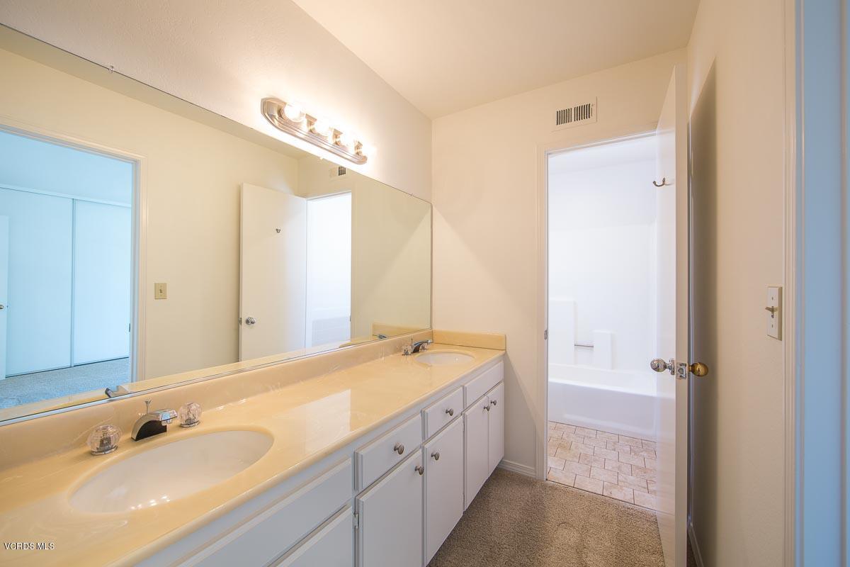 1854 Rory Lane, Unit 3 Simi Valley, CA 93063 - Photo 24 of 29 a spacious bathroom with a double vanity sink a mirror and a bathtub