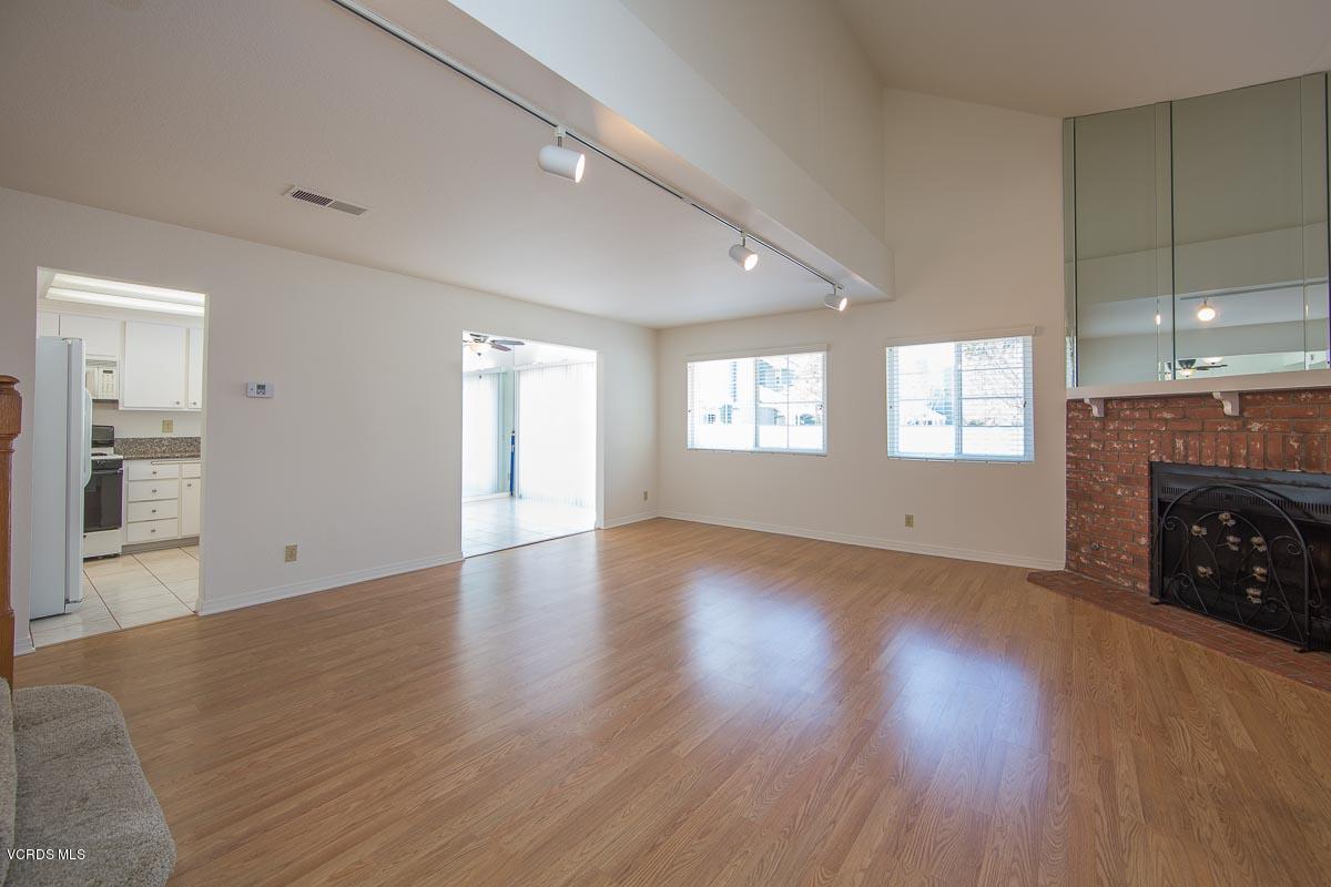 1854 Rory Lane, Unit 3 Simi Valley, CA 93063 - Photo 4 of 29 an empty room with wooden floor fireplace and windows