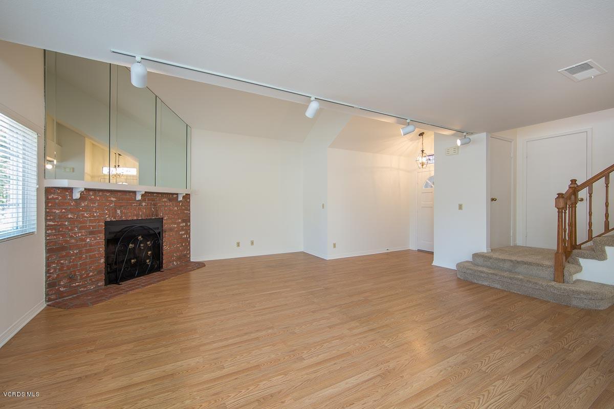 1854 Rory Lane, Unit 3 Simi Valley, CA 93063 - Photo 7 of 29 a view of empty room with wooden floor and fireplace