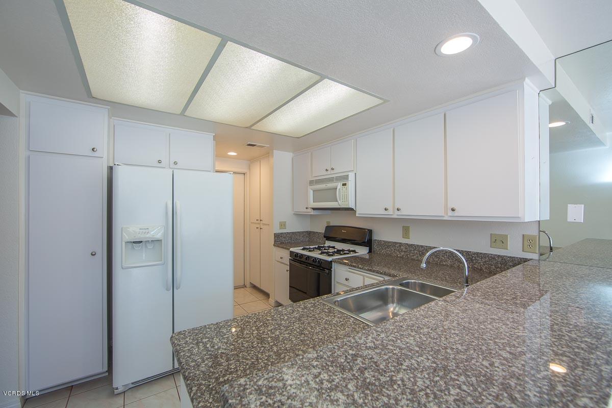 1854 Rory Lane, Unit 3 Simi Valley, CA 93063 - Photo 10 of 29 a kitchen with stainless steel appliances granite countertop a refrigerator sink and stove