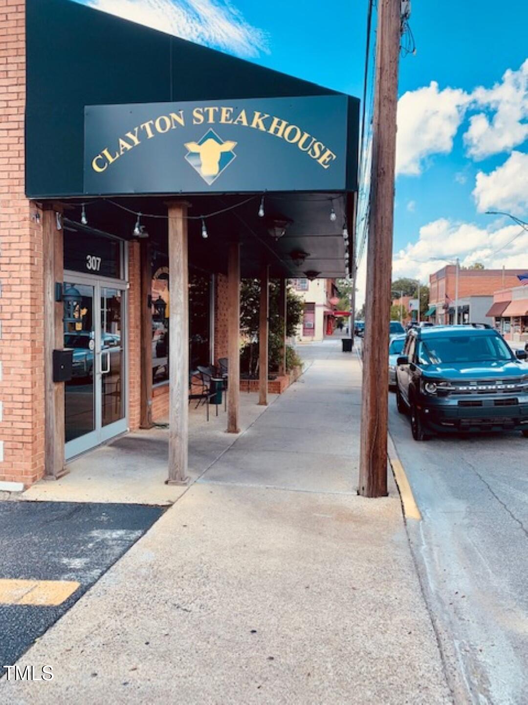 10 Nettle Lane, Unit 243 Clayton, NC 27520 - Photo 7 of 16 a view of a building with sitting area