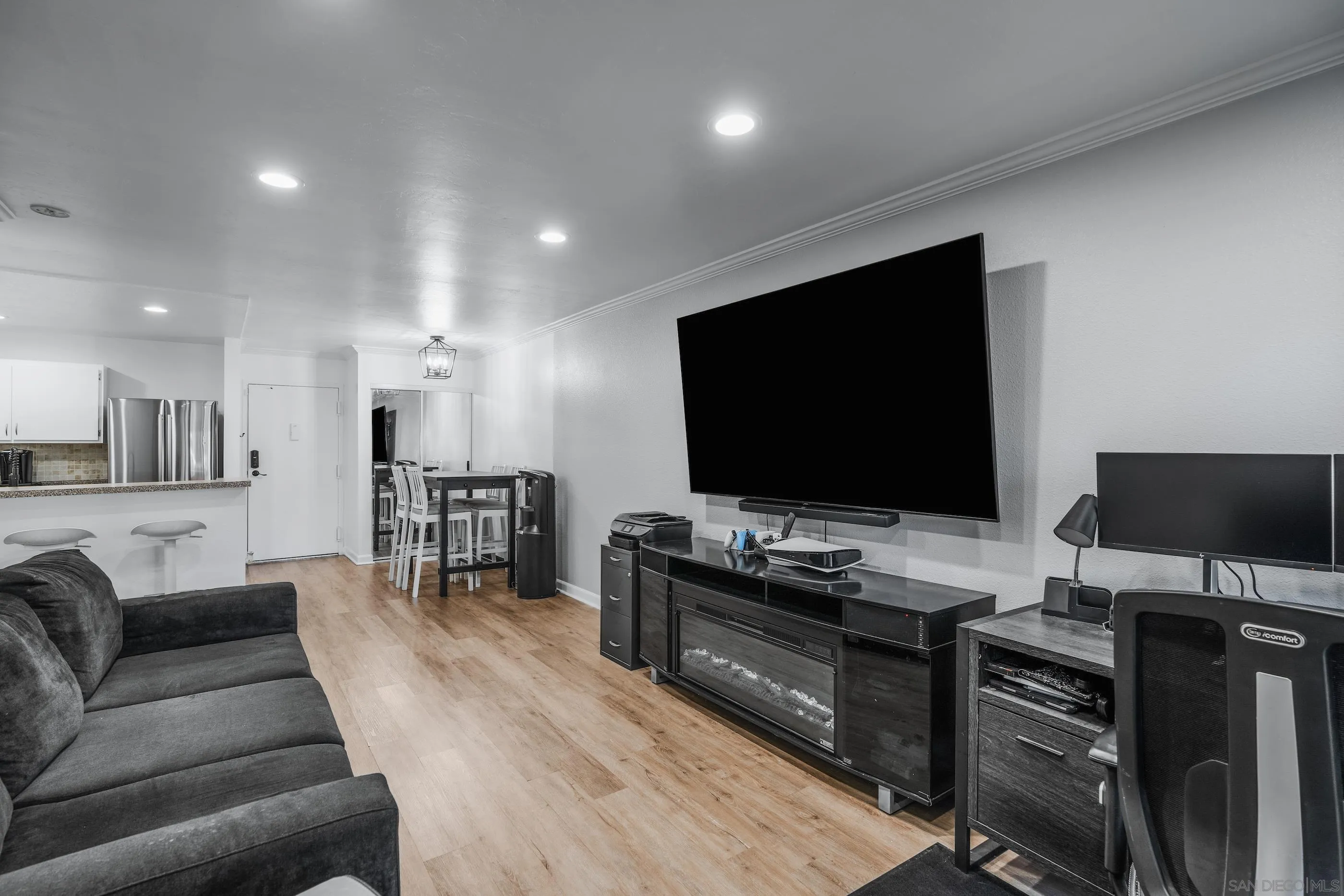 6275 Rancho Mission Road, Unit 105 San Diego, CA 92108 - Photo 12 of 24 a living room with furniture and a flat screen tv