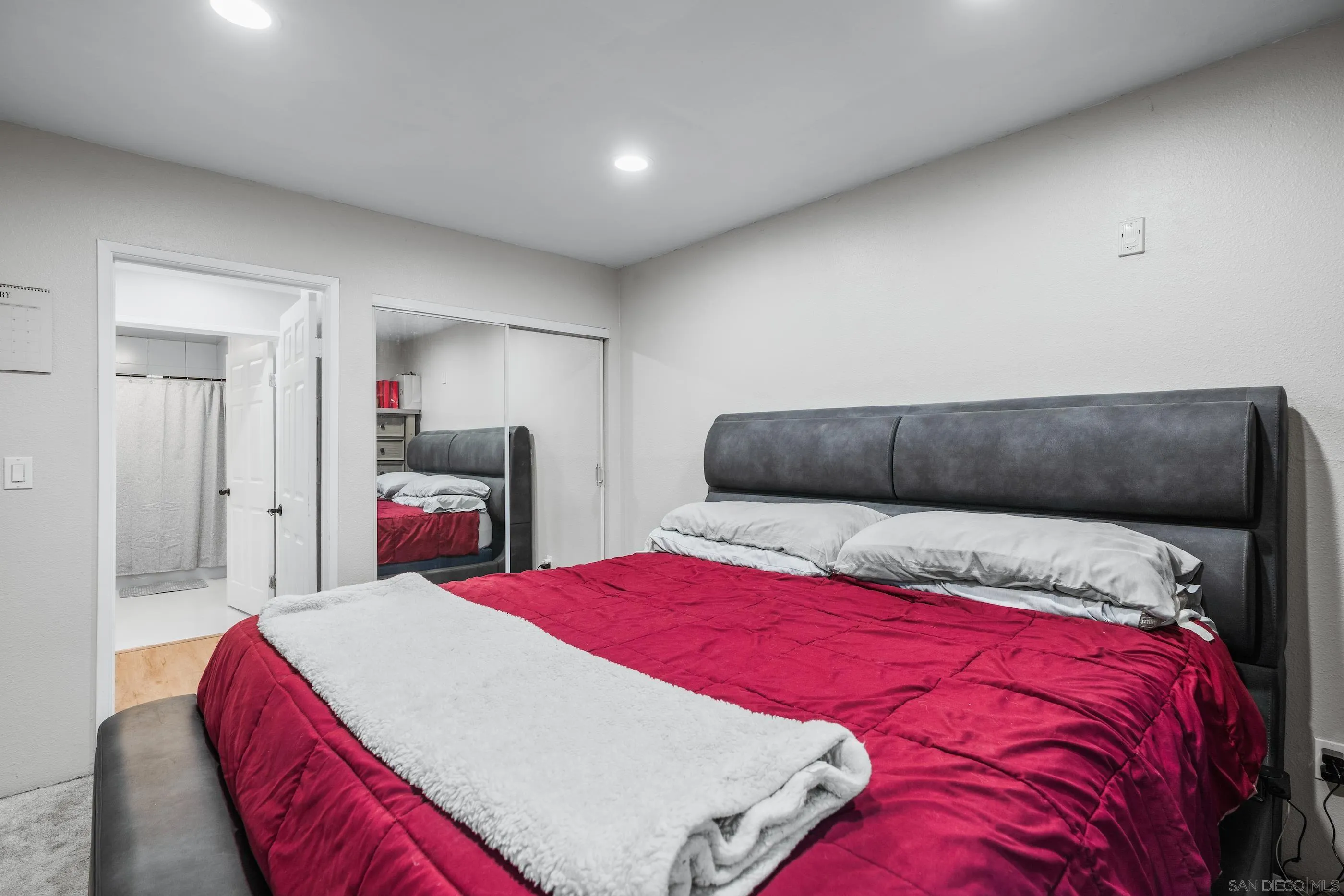 6275 Rancho Mission Road, Unit 105 San Diego, CA 92108 - Photo 20 of 24 a bedroom with a large bed and a closet