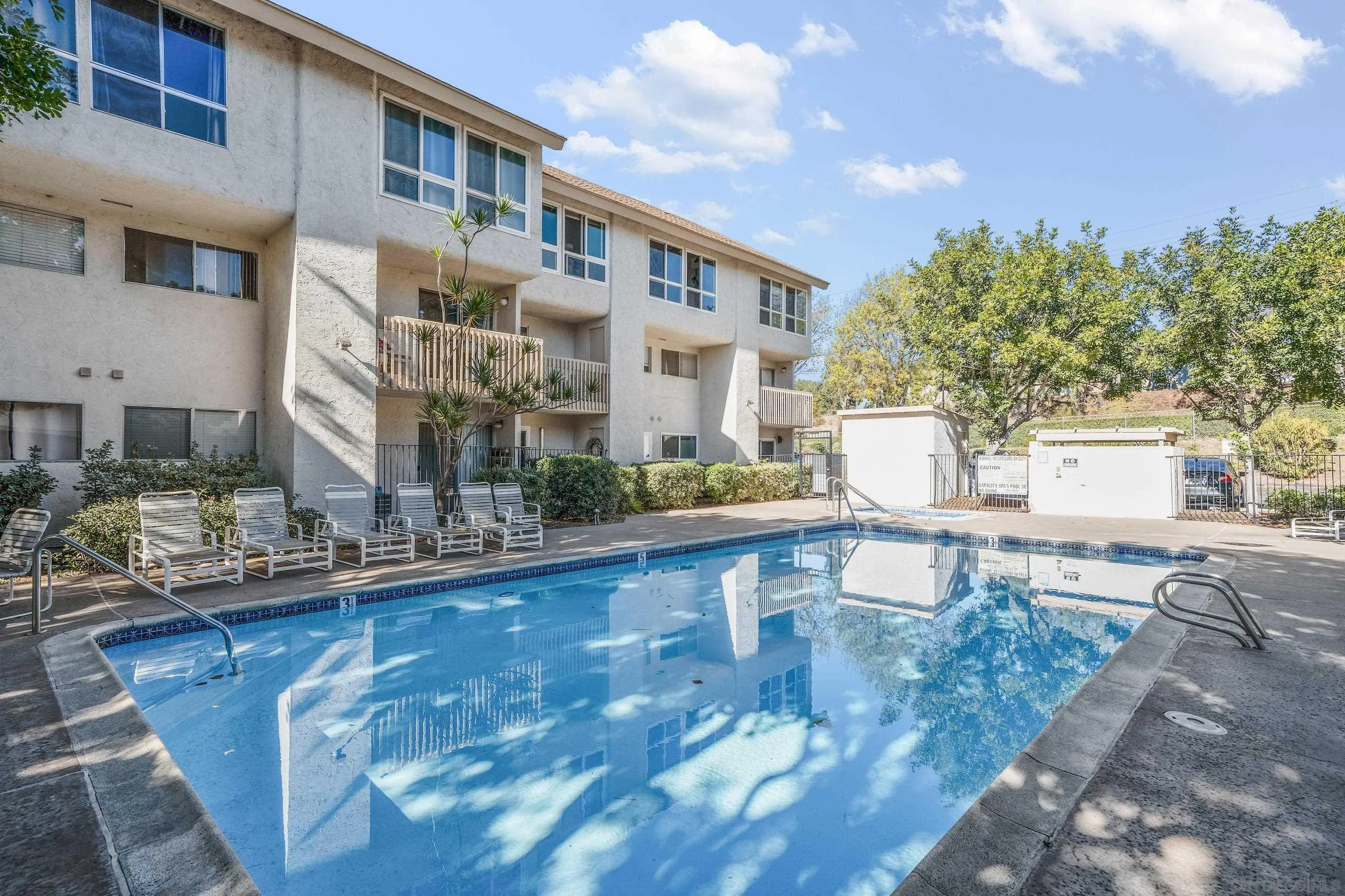 6275 Rancho Mission Road, Unit 105 San Diego, CA 92108 - Photo 22 of 24 a view of a building and with a swimming pool