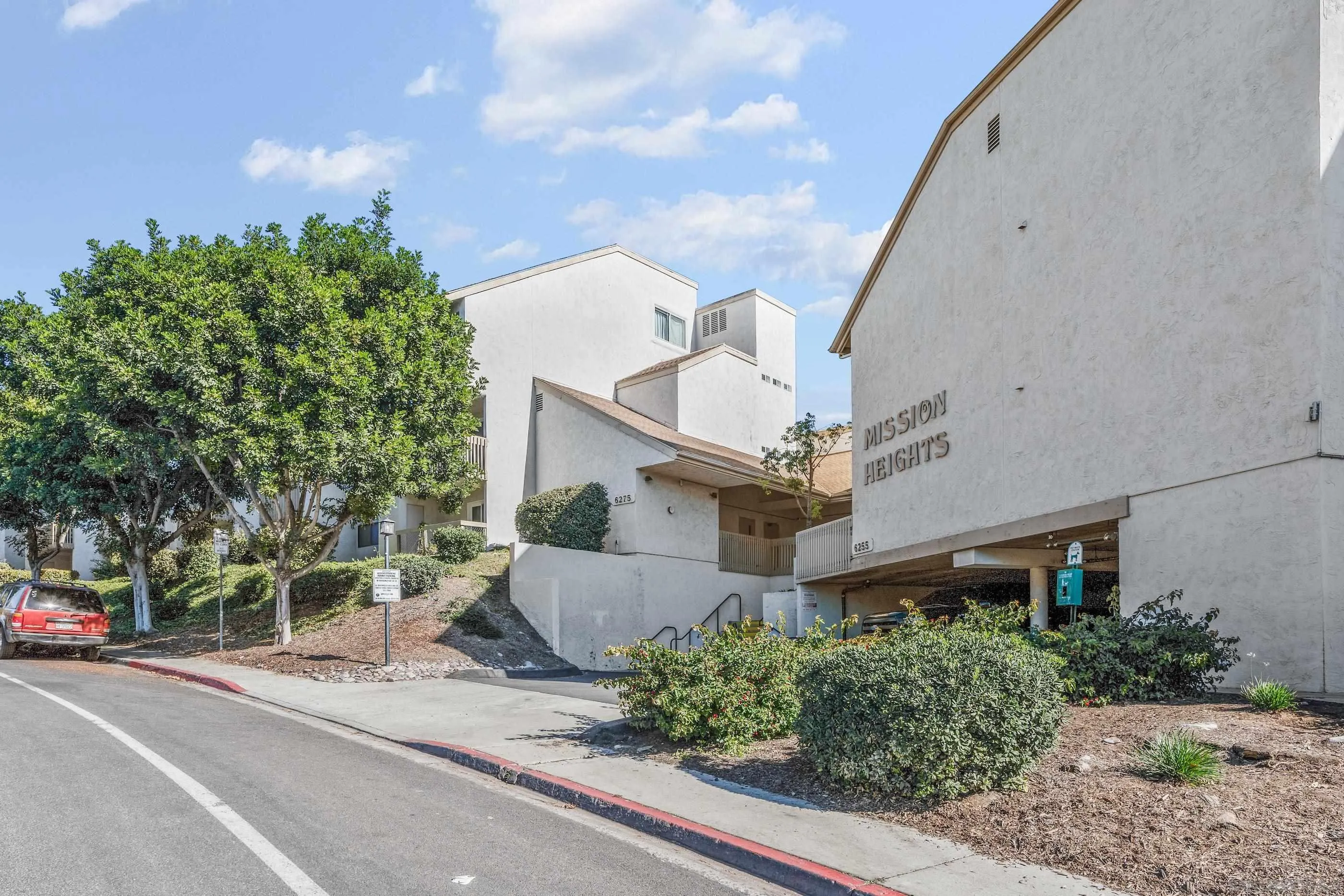 6275 Rancho Mission Road, Unit 105 San Diego, CA 92108 - Photo 24 of 24 a front view of a house with a yard and garage