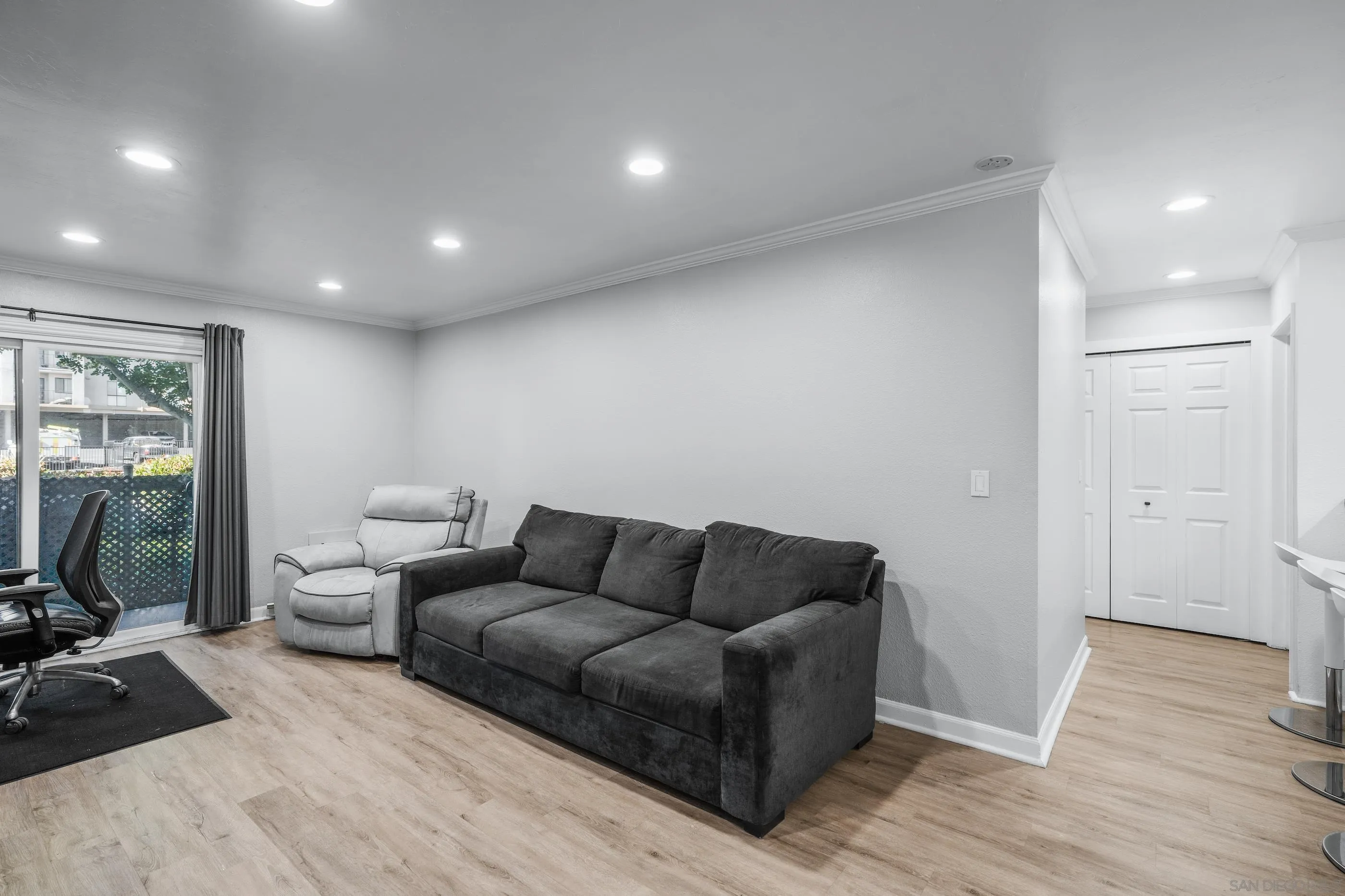6275 Rancho Mission Road, Unit 105 San Diego, CA 92108 - Photo 9 of 24 a living room with furniture and a flat screen tv