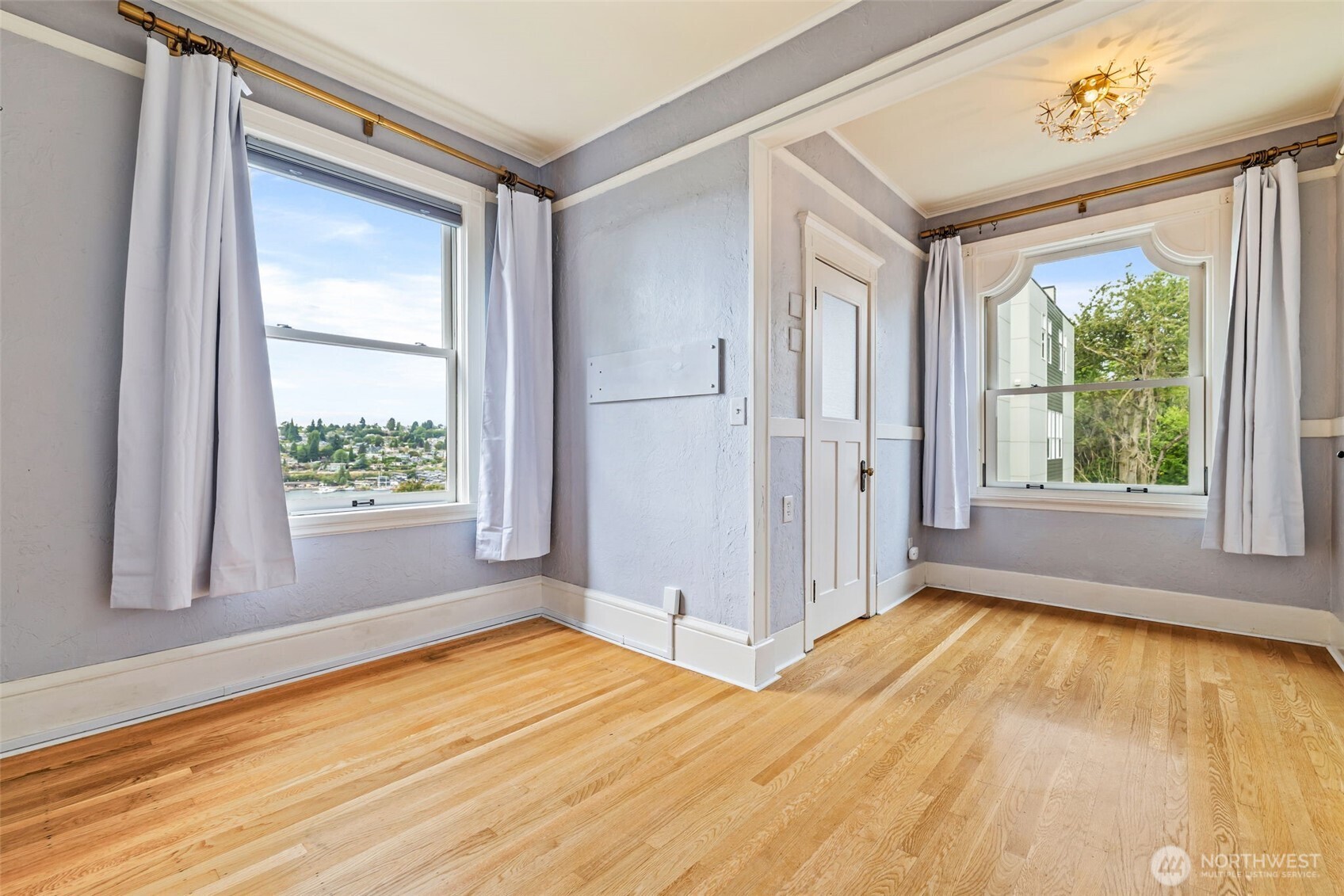 2915 Franklin Avenue East, Unit A Seattle, WA 98102 - Photo 18 of 34 a view of an empty room with a window and hardwood floor