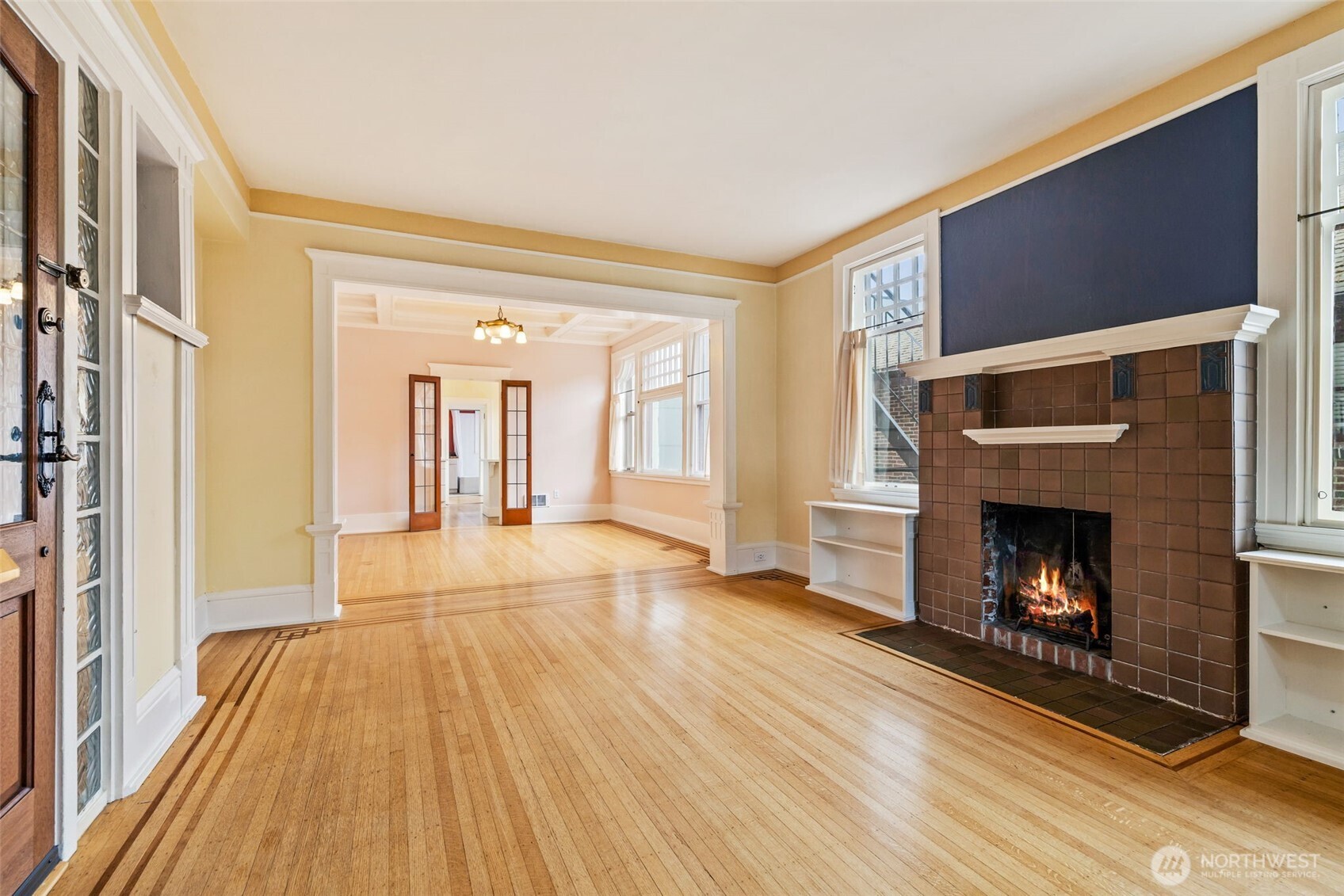 2915 Franklin Avenue East, Unit A Seattle, WA 98102 - Photo 7 of 34 a view of an empty room with wooden floor fireplace and a window