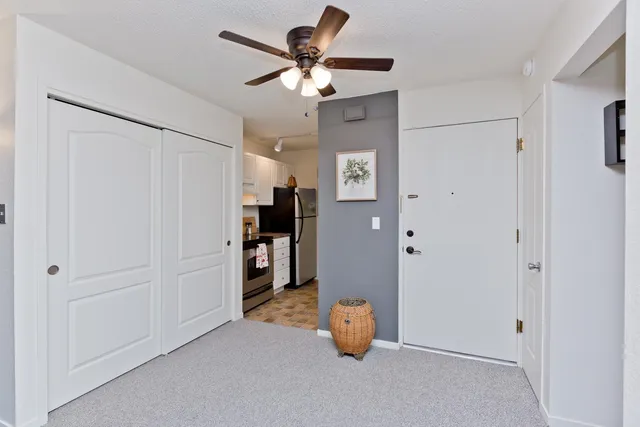 a view of an empty room with a ceiling fan