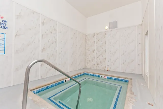 a view of swimming pool with outdoor seating and plants