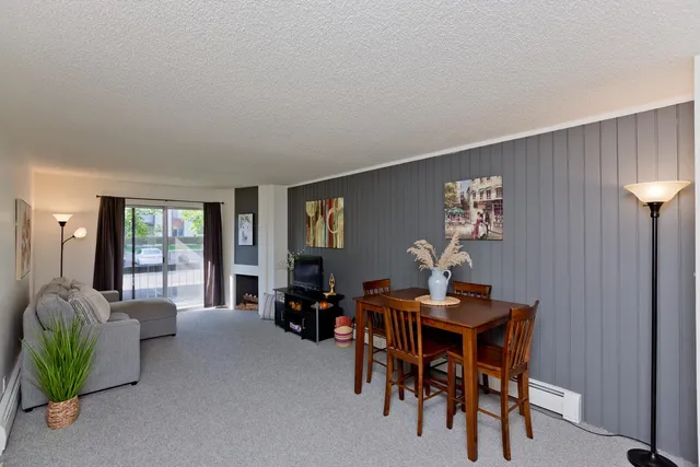 a dining room with furniture and window