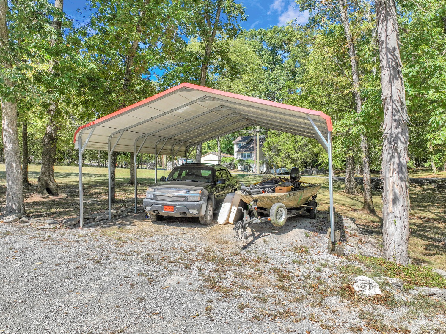 7004 Vanderbilt Road Old Hickory, TN 37138 - Photo 12 of 32 a backyard of a house with barbeque oven table and chairs