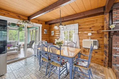 a dining room with furniture and floor to ceiling window
