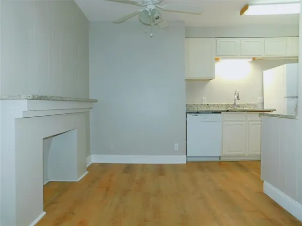 a view of a kitchen with a sink and a fireplace