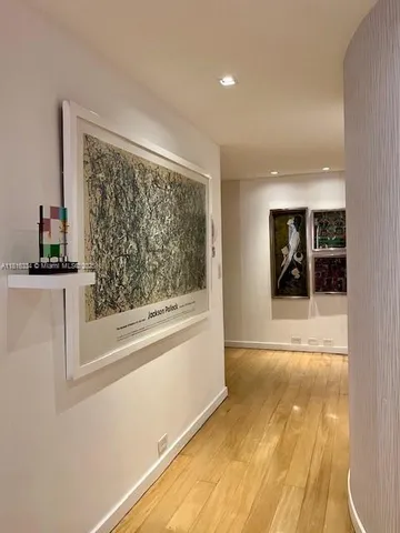 a view of kitchen with refrigerator and dining table