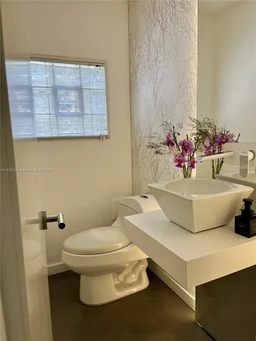 a bed sitting in a bedroom next to a book shelf