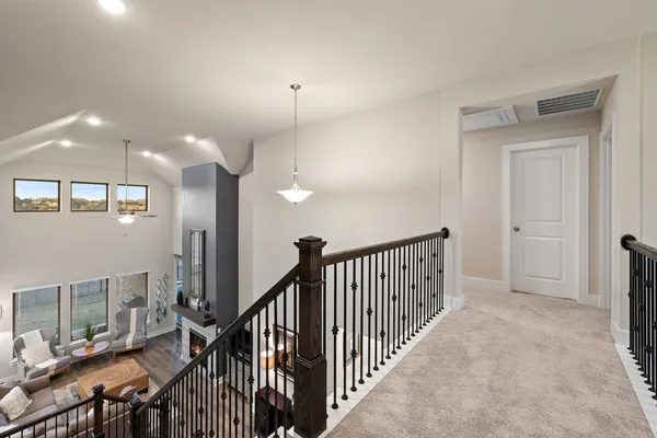 a view of a hallway with a livingroom with furniture