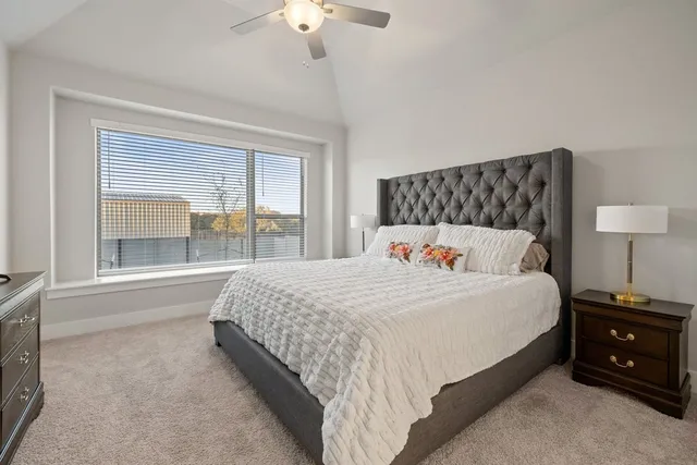 a bedroom with bed and a large window