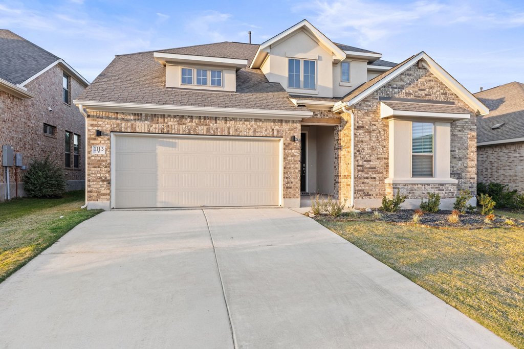 1113 Spring Gulch Lane Georgetown, TX 78628 - Photo 9 of 19 a front view of a house with a yard and garage