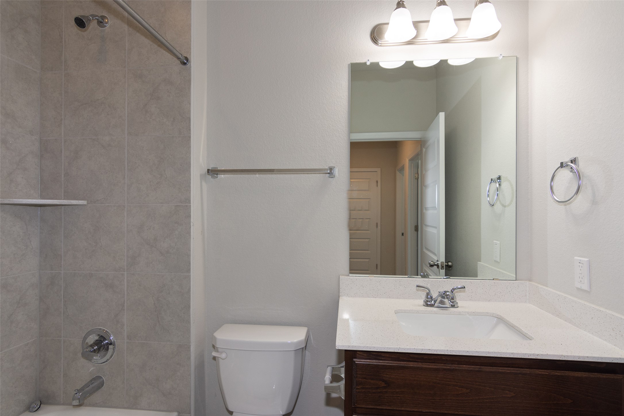 350 Fabion Street Kyle, TX 78640 - Photo 13 of 33 a bathroom with a sink a toilet and a mirror