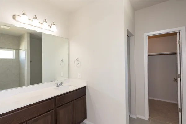 a bathroom with a double vanity sink and a mirror