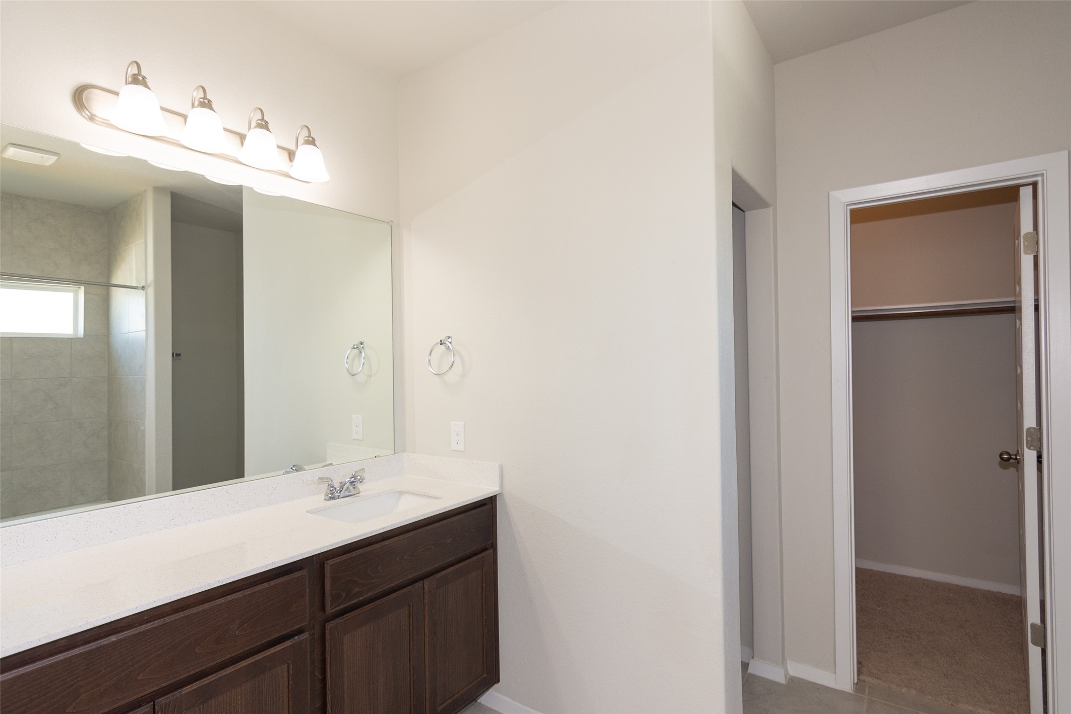 350 Fabion Street Kyle, TX 78640 - Photo 24 of 33 a bathroom with a double vanity sink and a mirror