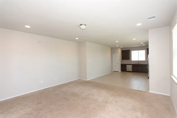 an empty room with a kitchen